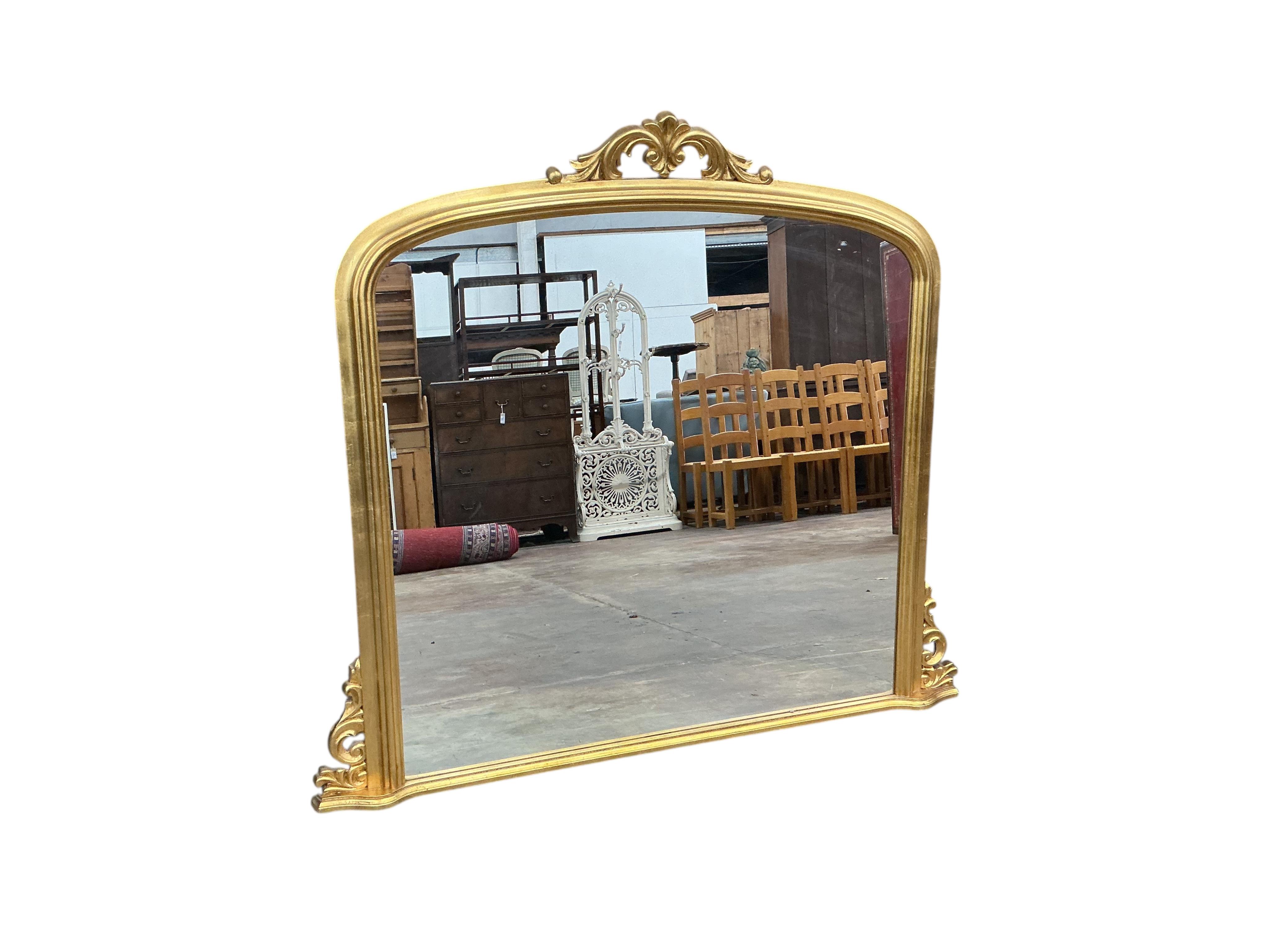 A Victorian style gilt composition overmantel mirror, width 184cm, height 110cm